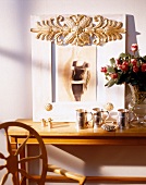 Gilded picture frame and cups in front on table