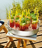 Cherry prosecco glasses on tray filled with ice on table