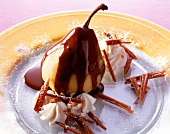 Close-up of pear with chocolate sauce and cinnamon on it