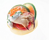 Close-up of crab, trout caviar, lemon on artichoke on white background