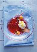 Close-up of strawberry soup in glass bowl on a blue napkin
