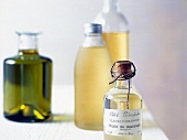 Different types of massage oils filled in different bottles on table