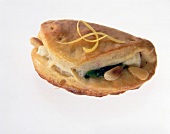 Close-up of spinach pies with garlic from pizza dough on white background
