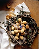 Wicker basket with baked eggs on wooden table for Easter