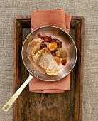 Chestnut crepes with caramelized mushrooms in pan on a wooden tray