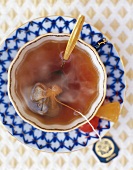 Cup of tea with tea bag and spoon, overhead view