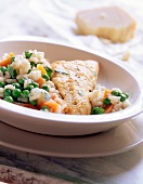 Close-up of fish with rice, carrots and peas on plate