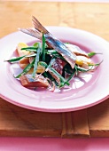 Salad with herring and beans on plate