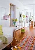 Large bright hallway with sofa, side lamp, chairs and striped carpet
