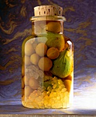 Figs and mirabelle with orange honey in glass jar with cork