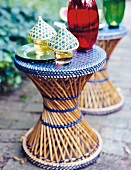 Glasses covered with bamboo hood kept on bamboo weaved stool