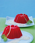 Melon jellies on white pate against blue background