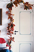 Door garland with berries, crab apples and leaves, autumn decoration