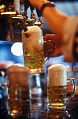 Close-up of beer being tapped in glass