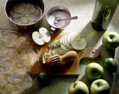 Green apple slices with lime squeeze on wooden board