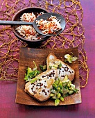 Tuna with cucumber on serving plate with bowl of rice