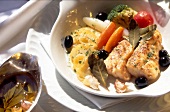 Baked silver perch with vegetables in serving dish