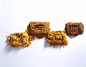 Four different varieties of mustard on white background, overhead view