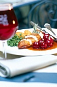 Chicken breast with cherries, rosemary and kriek sauce on plate