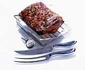 Meat on adjustable grid with meat thermometer on white background