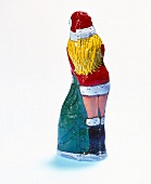 Figurine of female Santa Claus made of chocolate on white background