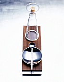 Glass carafe and bowl with spoon on walnut wooden tray