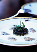 Close-up of oyster veloute with lemon and caviar on plate