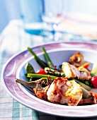 Monkfish with spring vegetables on a plate