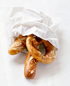 Various lye pretzels in white bag