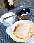 Close-up of poached semolina strudel served with ice cream stewed in pot