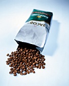 Close-up of coffee beans spilling from paper bag