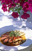 Deer fillets with thyme on plate