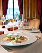 Celery ravioli with truffle and Madeira sauce on plate