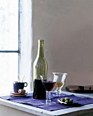 Grape juice in glass and bottle on table