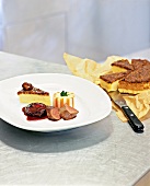 Shoulder of venison with potato and chestnut tart on plate