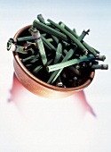 Close-up of copper bowl filled with pieces of dried green horsetail