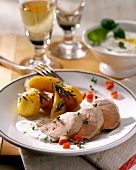 Pork fillet with potato and basil dip on plate