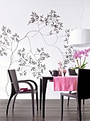 Dining room with black and white floral wallpaper and dining table