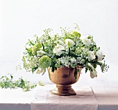 White and green spring flowers in champagne bucket