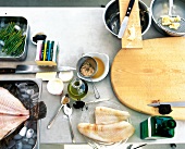 Turbot fillets with green asparagus being prepared, overhead view