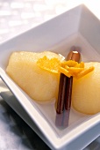 Close-up of pears with vanilla sticks and orange peel in a bowl