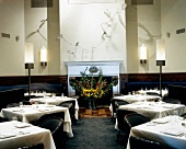 Restaurant with covered tables and flowers at Dylan Hotel, New York