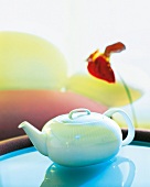 Teapot on blue table