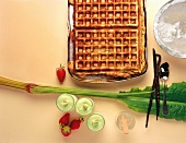 Preparation of waffles with strawberries, vanilla pods and basil