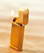 Close-up of gold plated lighter with vertical godrons