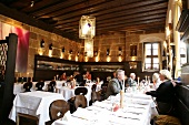 People sitting at table in restaurant, Germany