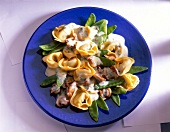 Tortellini with mushrooms and sugar snap peas on plate