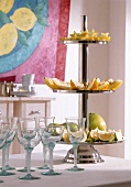 Fruits on stainless steel cake stand and various glass goblets
