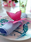 Napkin decorated with paper butterfly on silk ribbon