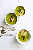 Three cups of vegetable soup with lovage and three spoons